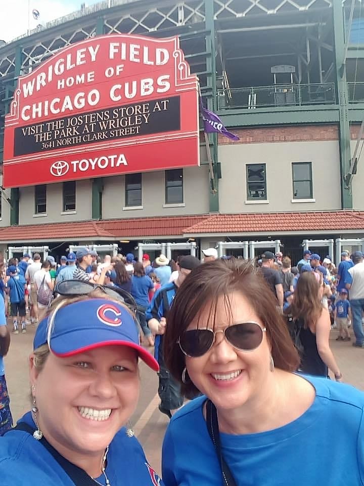 two girls in front of Wrigley Field sign