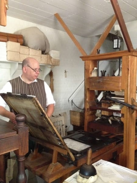 man at a printing press