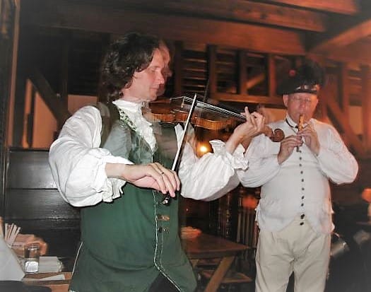 men playing music on instruments in a tavern