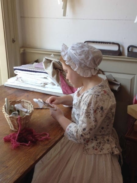 girl sewing at a table