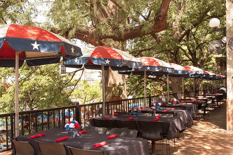 Texas state flag umbrellas line a restaurant in San Antonio, Texas