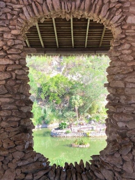 view of Sunken Gardens in San Antonio through a rock formation