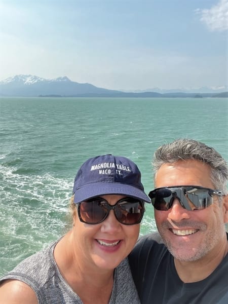 man and woman on balcony of cruise ship