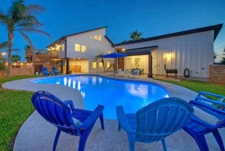Port Aransas pool overlooking yard and house