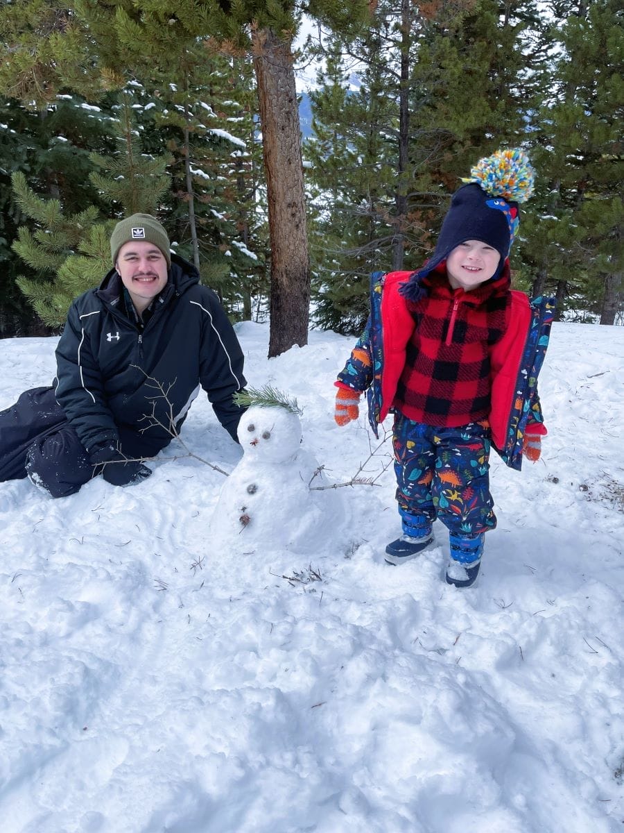 Man and boy building a snowman in Breckenridge