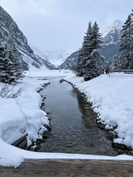 babbling creek leading to frozen lake at Fairmont Chateau Lake Louise