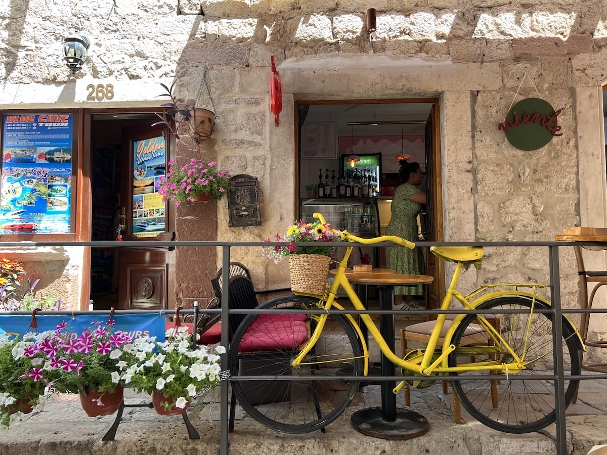 Kotor City with a bicycle and plants in front of a shop