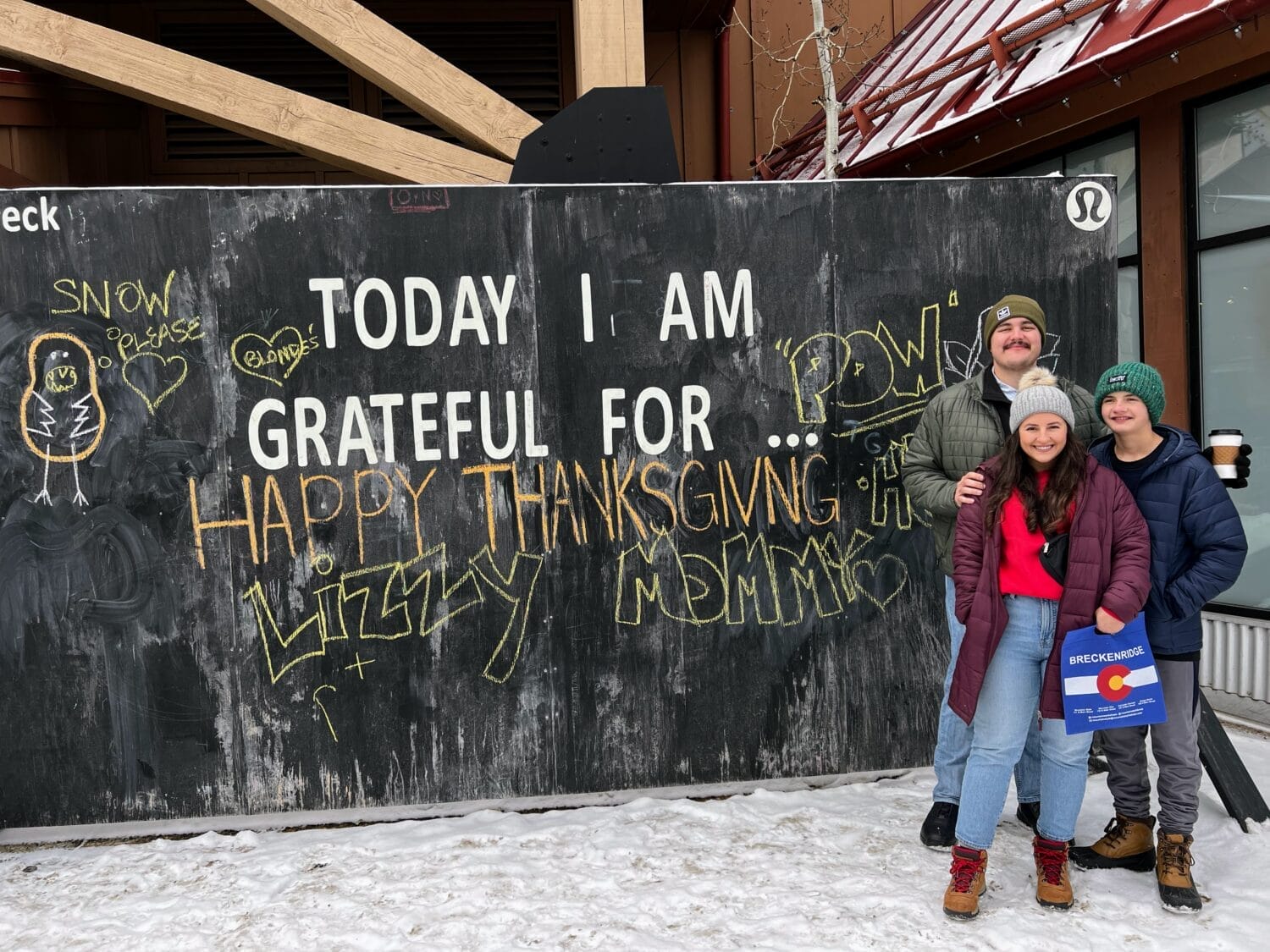 Thanksgiving mural in Breckenridge with family standing in front of it