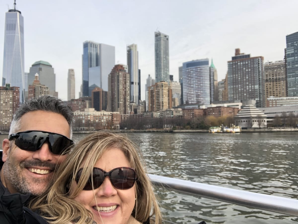 man and woman in front of NYC skyline in December