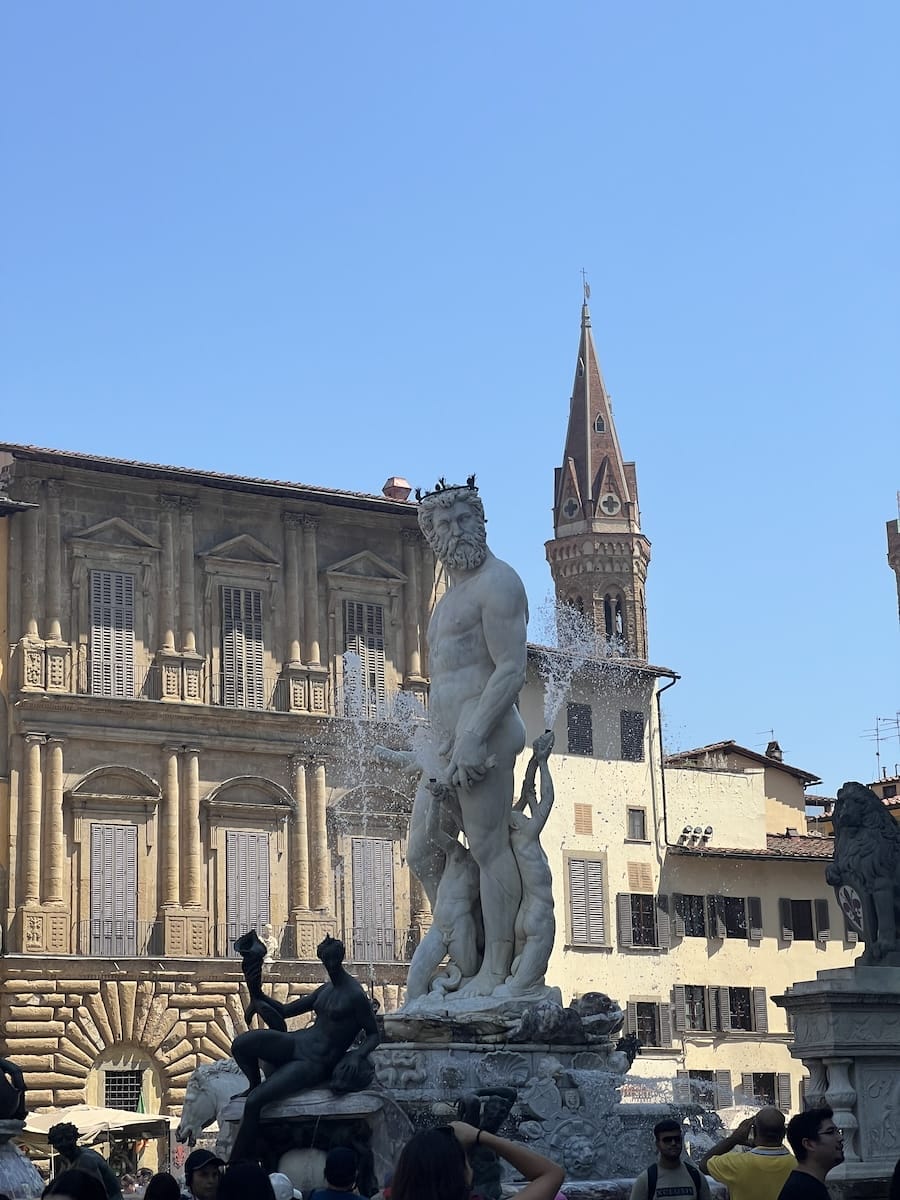 statue of Neptune with tower in background