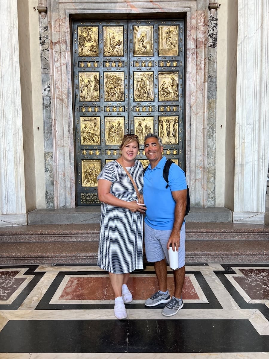 man and woman in front of Holy Doors at Vatican