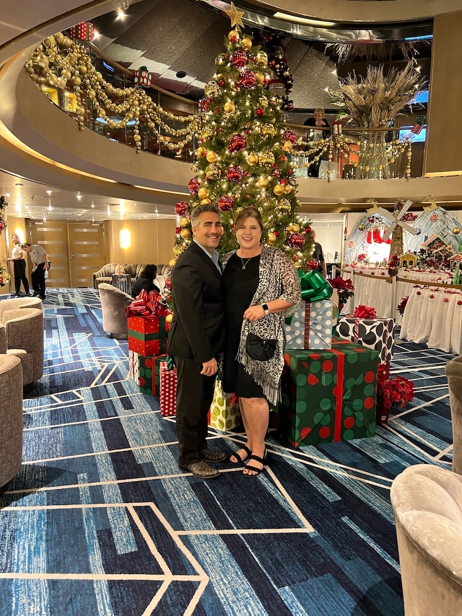 couple in front of Christmas tree onboard a cruise ship