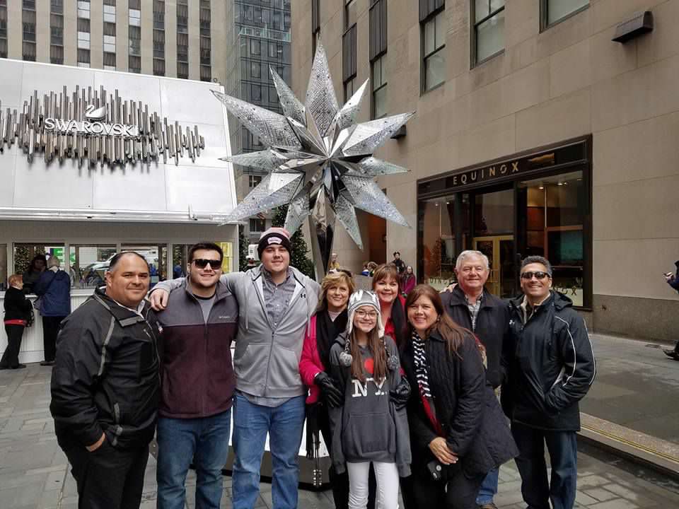 family in front of Swarovski star topper